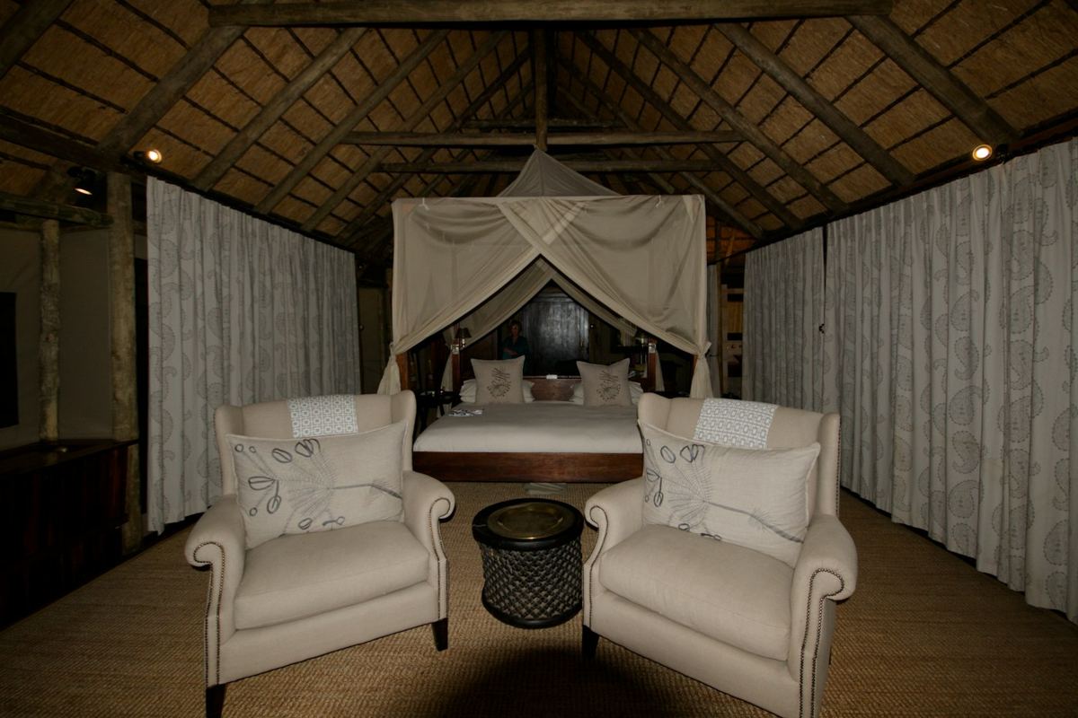 Lodge suite with a canopy bed and armchairs
