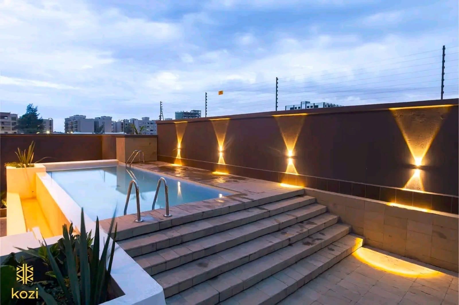 Rooftop pool with warm wall lights